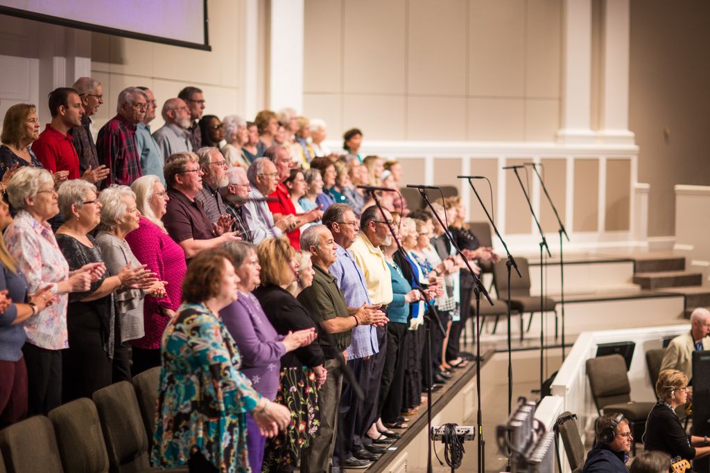 A diverse choir performing in a modern church setting, showcasing unity and harmony.